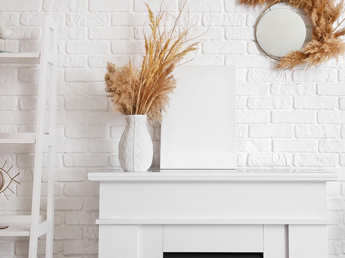 White stone fireplace with pompas in a white vase